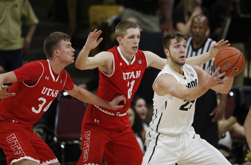 Colorado forward Lucas Siewert, right, juggles the ball while fielding a pass in front of Utah forwards Tyler Rawson, center, and Jayce Johnson during the first half of an NCAA college basketball game Thursday, Feb. 23, 2017, in Boulder, Colo. (AP Photo/David Zalubowski)