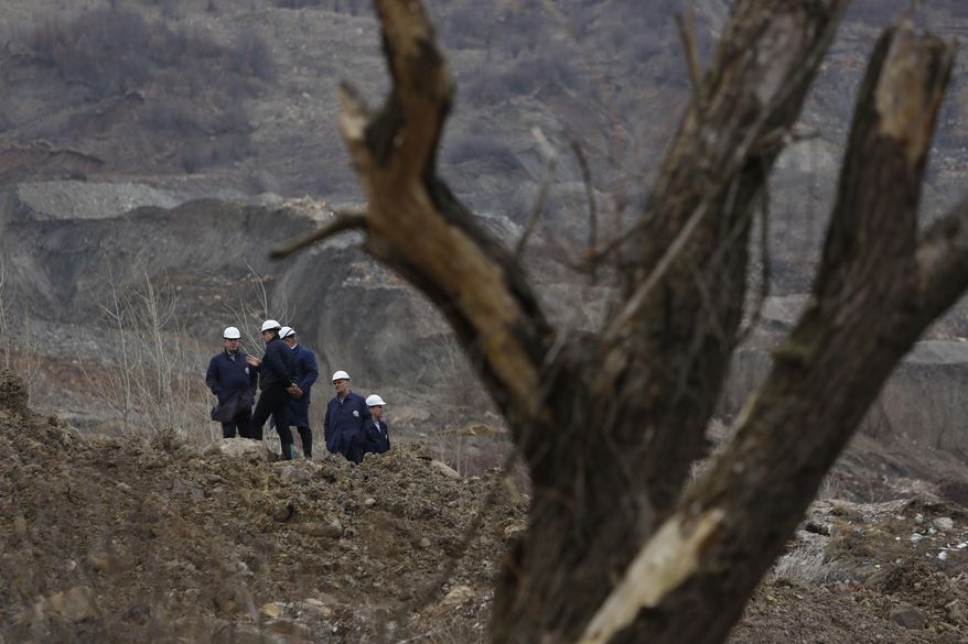 Engineers surveying the damage after a landslide near the Bosnian town of Kakanj, 50 kms north of Sarajevo on Friday, Feb. 24, 2017. More than 150 people have been forced to evacuate their homes in central Bosnia due to a major landslide at a nearby open pit coal mine that has threatened to bury their villages. ( AP Photo/Amel Emric)