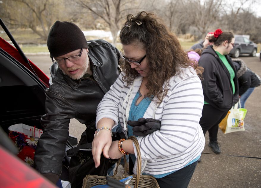 ADVANCE FOR WEEKEND EDITIONS - In this Saturday, Feb. 18, 2017, photo, David Koffer, left, and his wife Wendy Koffer gather equipment from their vehicle to collect plants with at Rock Creek Park in Twin Falls, Idaho. (Pat Sutphin/The Times-News via AP)