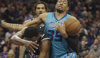 Charlotte Hornets forward Christian Wood, right, pulls a rebound away from Sacramento Kings guard Tyreke Evans during the first half of an NBA basketball game Saturday, Feb. 25, 2017, in Sacramento, Calif. (AP Photo/Rich Pedroncelli)