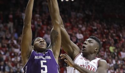 Northwestern&#39;s Dererk Pardon puts up a shot against Indiana&#39;s Thomas Bryant during the first half of an NCAA college basketball game Saturday, Feb. 25, 2017, in Bloomington, Ind. (AP Photo/Darron Cummings)