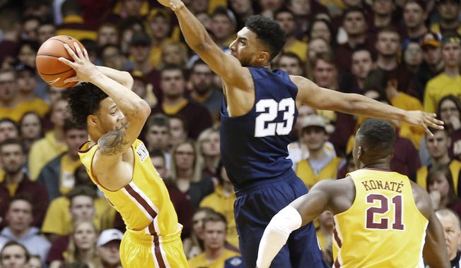 Minnesota&#x27;s Amir Coffey, left, keeps the ball away from Penn State&#x27;s Josh Reaves, center, during the first half of an NCAA college basketball game Saturday, Feb. 25, 2017, in Minneapolis. (AP Photo/Jim Mone)