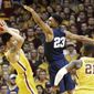 Minnesota&#x27;s Amir Coffey, left, keeps the ball away from Penn State&#x27;s Josh Reaves, center, during the first half of an NCAA college basketball game Saturday, Feb. 25, 2017, in Minneapolis. (AP Photo/Jim Mone)