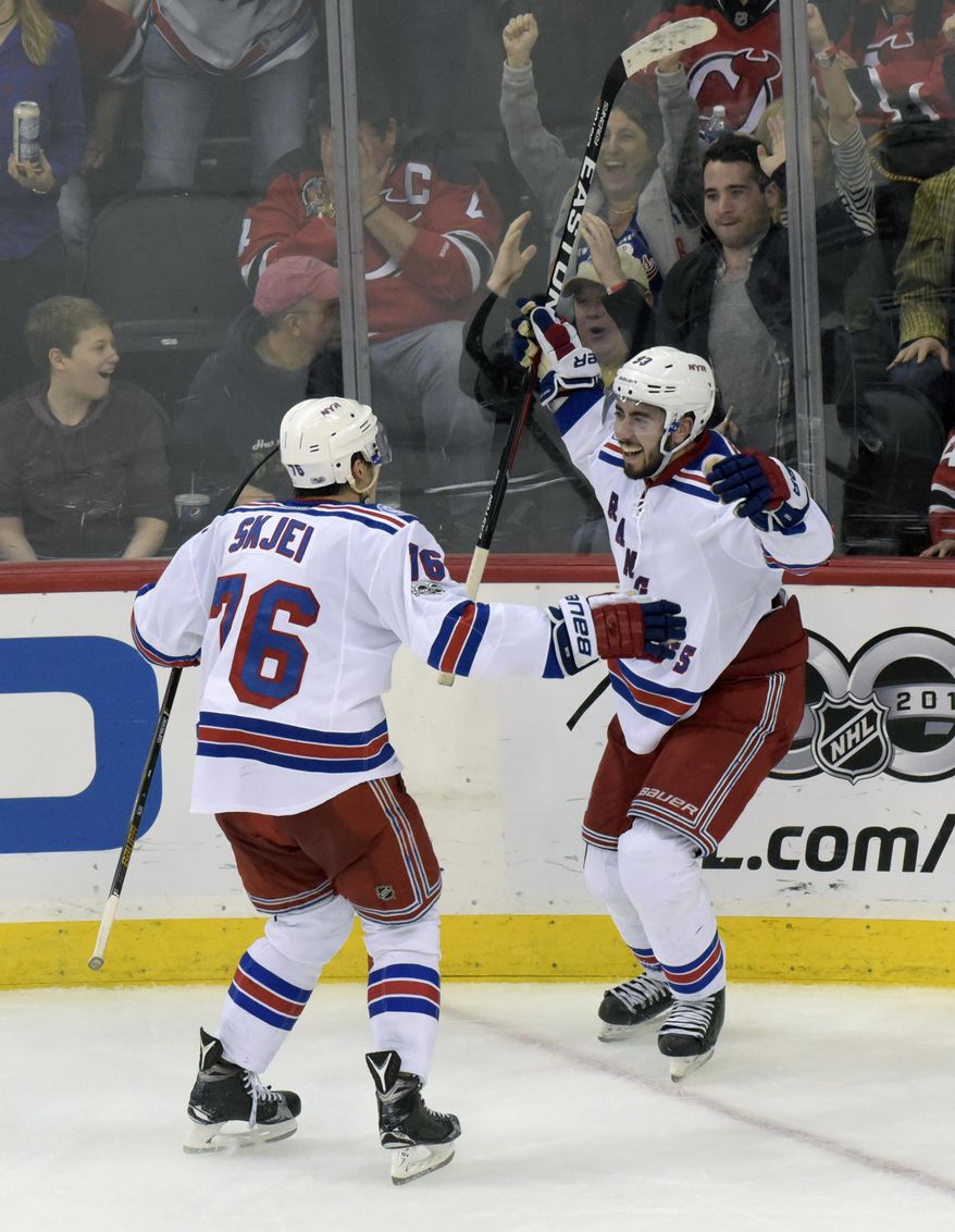 New York Rangers&#39; Mika Zibanejad, right, celebrates his overtime goal with Brady Skjei during an NHL hockey game against the New Jersey Devils, Saturday, Feb. 25, 2017, in Newark, N.J. (AP Photo/Bill Kostroun)