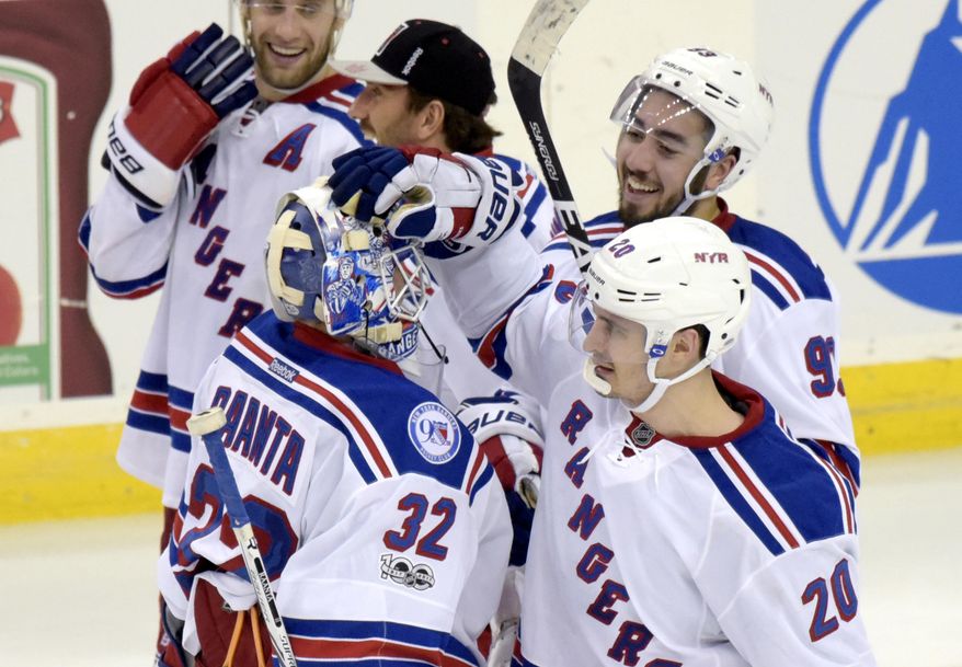 New York Rangers goaltender Antti Raanta celebrates wth Chris Kreider (20) and Mika Zibanejad after defeating the New Jersey Devils 4-3 in the overtime period of an NHL hockey game Saturday, Feb. 25, 2017, in Newark, N.J. (AP Photo/Bill Kostroun)