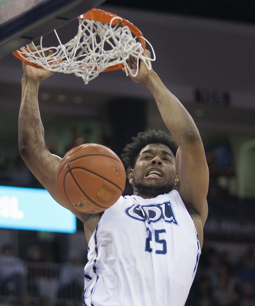 Old Dominion University's Brandan Stith slams home the alley-oop pass in the first half of an NCAA college basketball game against Western Kentucky University, Saturday, Feb. 25, 2017, in Norfolk, Virginia. (L. Todd Spencer/The Virginian-Pilot via AP)
