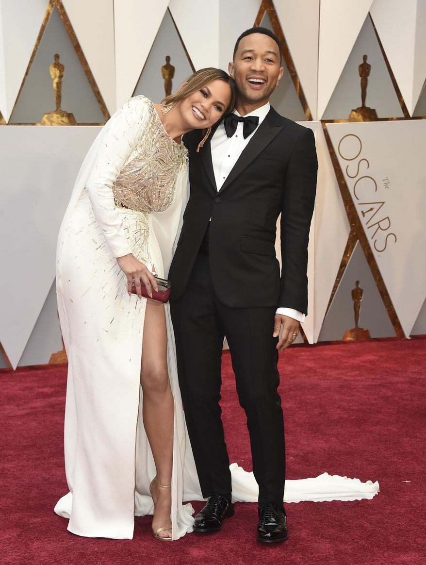 Chrissy Teigen, left, and John Legend arrive at the Oscars on Sunday, Feb. 26, 2017, at the Dolby Theatre in Los Angeles. (Photo by Jordan Strauss/Invision/AP)