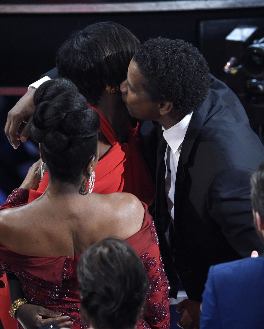 Denzel Washington, right, congratulates Viola Davis, winner of the award for best actress in a supporting role for "Fences" at the Oscars on Sunday, Feb. 26, 2017, at the Dolby Theatre in Los Angeles. (Photo by Chris Pizzello/Invision/AP)