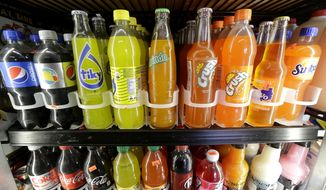 In this Sept. 21, 2016, file photo, soft drink and soda bottles are displayed in a refrigerator at El Ahorro market in San Francisco. (AP Photo/Jeff Chiu, File)
