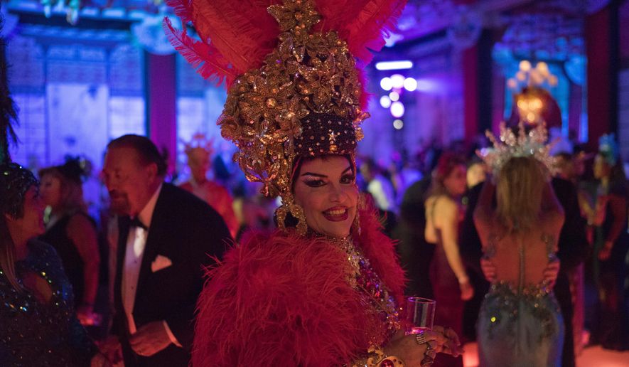 A guest in a costume poses for the photo as she enjoys a traditional Carnival ball at the Copacabana Palace hotel in Rio de Janeiro, Brazil, Saturday, Feb. 25, 2017. In stark contrast to the hundreds of hard-charging street parties across Rio that are open to anyone, the "Baile do Copa" bills itself as a fairytale event where the country's elite can see and be seen in a hotel known for both opulence and a lengthy tradition of welcoming world leaders and stars. (AP Photo/Leo Correa)