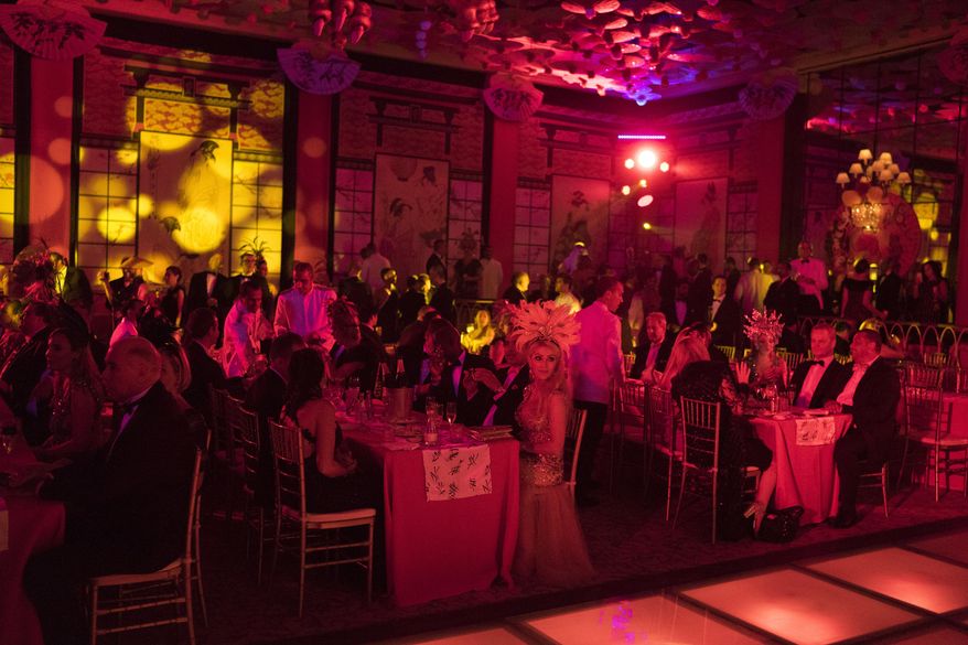 Guests enjoy a traditional Carnival ball at the Copacabana Palace hotel in Rio de Janeiro, Brazil, Saturday, Feb. 25, 2017. In stark contrast to the hundreds of hard-charging street parties across Rio that are open to anyone, the "Baile do Copa" bills itself as a fairytale event where the country's elite can see and be seen in a hotel known for both opulence and a lengthy tradition of welcoming world leaders and stars. (AP Photo/Leo Correa)