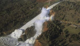 FILE - This Saturday, Feb. 11, 2017, file aerial photo released by the California Department of Water Resources shows the damaged spillway with eroded hillside in Oroville, Calif. California water authorities will cut the outflow from the dam to allow workers to remove debris piled at the base of its main spillway. The Department of Water Resources said Sunday, Feb. 26, 2017 it will start gradually reducing outflows from the Oroville Dam in Northern California starting Monday morning and completely stop them by the afternoon. (William Croyle/California Department of Water Resources via AP, File)
