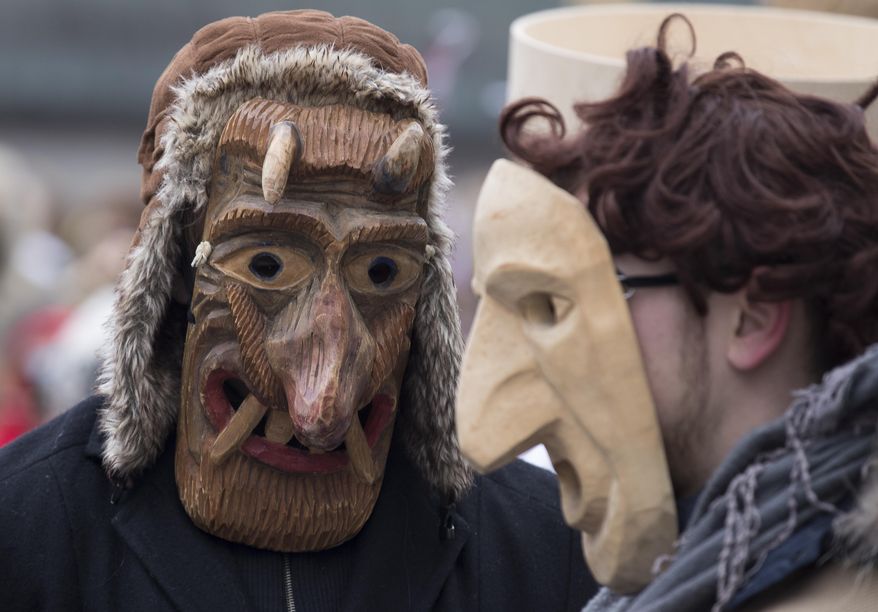 Revellers wearing masks take part in the International Mask Festival in Riga, Latvia, Sunday, Feb. 26, 2017. (AP Photo/Mindaugas Kulbis)