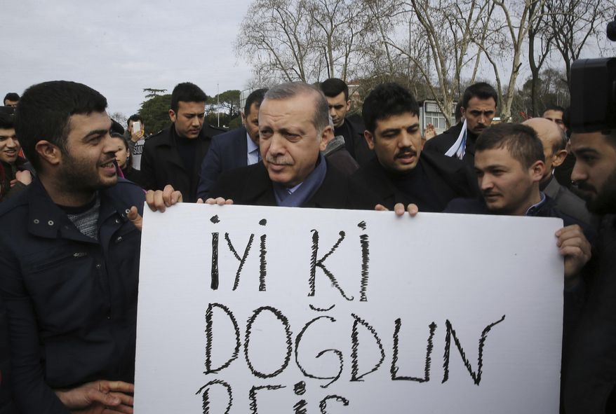 Supporters hold a placard that reads &amp;quot;happy birthday, leader&amp;quot; as they gather outside the residence of Turkey&#x27;s President Recep Tayyip Erdogan to celebrate his birthday, in Istanbul, Sunday, Feb. 26, 2017. Turkey will hold a national referendum in April 16 on expanding Erdogan&#x27;s powers. Critics say it would concentrate even more power in the hands of a leader they accuse of authoritarian behavior. The reforms would potentially allow Erdogan, 63, to remain in power until 2029.(Kayhan Ozer/Presidential Press Service, Pool Photo via AP)