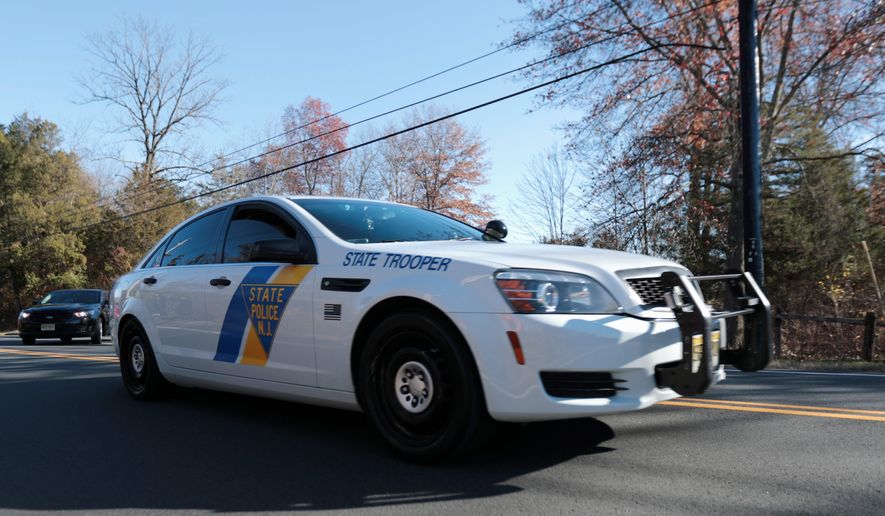 A New Jersey State Police cruiser leaves Trump National Golf Club, Friday, Nov. 18, 2016, in Bedminster, N.J. President-elect Donald Trump is expected to arrive at the golf club on Friday. (AP Photo/Julio Cortez)