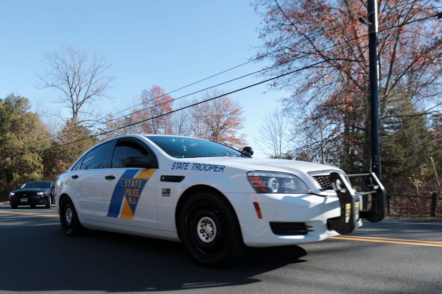 A New Jersey State Police cruiser leaves Trump National Golf Club, Friday, Nov. 18, 2016, in Bedminster, N.J. President-elect Donald Trump is expected to arrive at the golf club on Friday. (AP Photo/Julio Cortez)