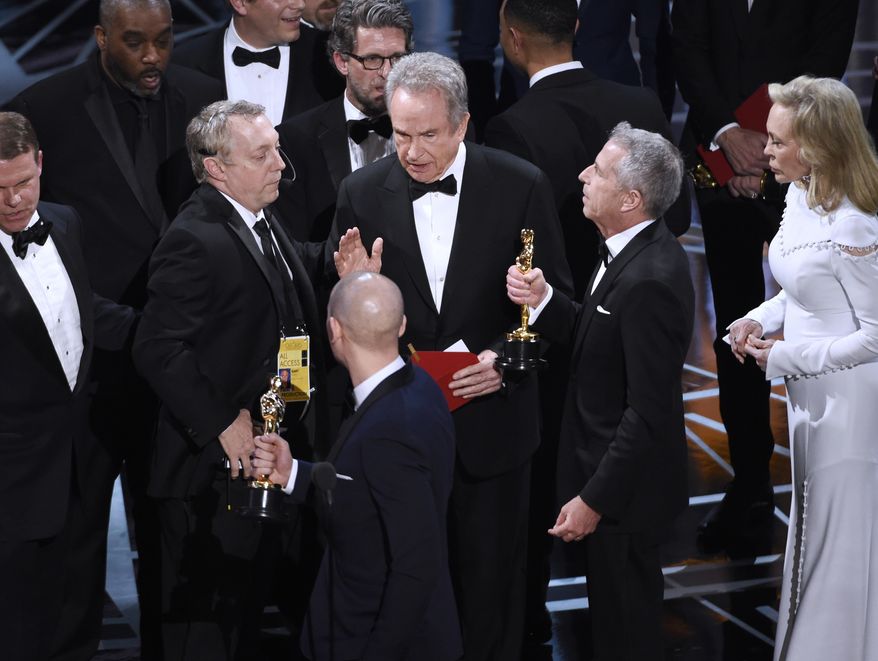 Warren Beatty, center, discusses the results of the award for best picture with Academy of Motion Pictures Arts and Sciences officials and producers from "La La Land" at the Oscars on Sunday, Feb. 26, 2017, at the Dolby Theatre in Los Angeles. (Photo by Chris Pizzello/Invision/AP)
