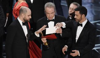 &amp;quot;La La Land&amp;quot; producer Jordan Horowitz, left, presenter Warren Beatty, center, and host Jimmy Kimmel right, look at an envelope announcing &amp;quot;Moonlight&amp;quot; as best picture at the Oscars on Sunday, Feb. 26, 2017, at the Dolby Theatre in Los Angeles. It was originally announced mistakenly that &amp;quot;La La Land&amp;quot; was the winner. (Photo by Chris Pizzello/Invision/AP)