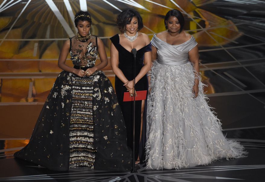 Janelle Monae, from left, Taraji P. Henson, and Octavia Spencer present the award for best documentary feature at the Oscars on Sunday, Feb. 26, 2017, at the Dolby Theatre in Los Angeles. (Photo by Chris Pizzello/Invision/AP)