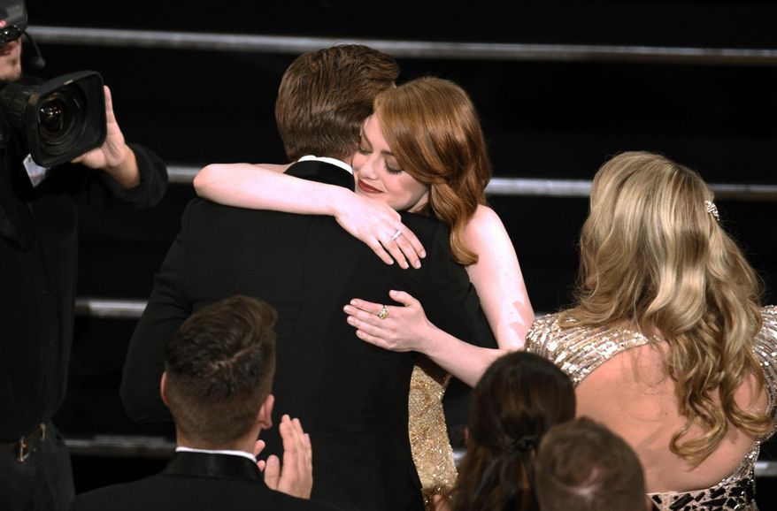 Ryan Gosling, right, congratulates Emma Stone as she accepts the award for best actress in a leading role for "La La Land" at the Oscars on Sunday, Feb. 26, 2017, at the Dolby Theatre in Los Angeles. (Photo by Chris Pizzello/Invision/AP)