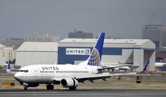 FILE - In this Sept. 8, 2015, file photo, a United Airlines passenger plane lands at Newark Liberty International Airport in Newark, N.J. United Airlines seeks to narrow gap on competitors like Delta by beefing up routes from hub airports. The airline also wants to upgrade facilities at key airports and reduce its use of smaller planes on important business-travel routes. (AP Photo/Mel Evans, File)