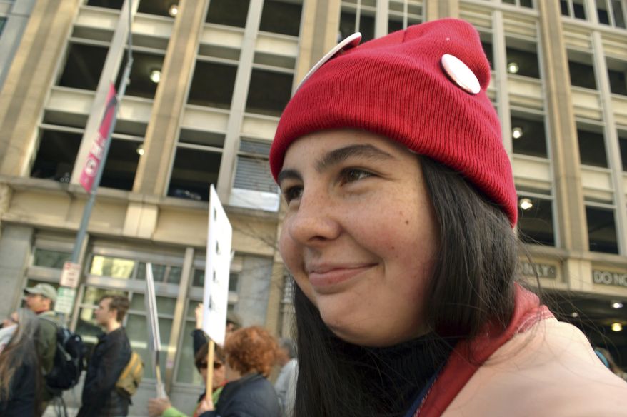 Hattie Haines, 14, who describes herself as a liberal Democrat, marches at the Moral March on Feb. 11, 2017 in Raleigh, N.C. Haines is one of 790 teenagers between the ages of 13 and 17 who participated in a first-of-its-kind Associated Press-NORC Center for Public Affairs poll on teens' social media use, political views and political outlook. (Mars Glaspie via AP)