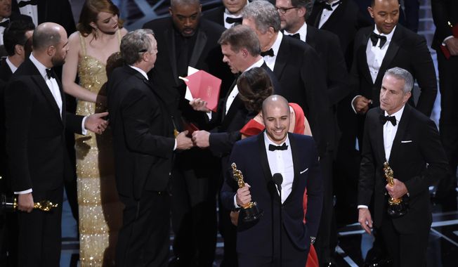 Fred Berger, producer of &amp;quot;La La Land,&amp;quot; foreground center, gives his acceptance speech as members of PricewaterhouseCoopers, Brian Cullinan, holding red envelope, and Martha L. Ruiz, in red dress, and a stage manager discuss the best picture announcement error among the cast at the Oscars on Sunday, Feb. 26, 2017, at the Dolby Theatre in Los Angeles. The actual winner of best picture went to &amp;quot;Moonlight.&amp;quot; (Photo by Chris Pizzello/Invision/AP)