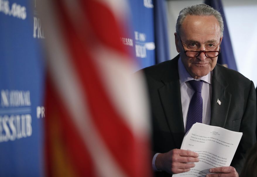 Senate Minority Leader Chuck Schumer of N.Y. walks back to his seat after giving opening remarks during a news conference at the National Press Club in Washington, Monday, Feb. 27, 2017. (AP Photo/Alex Brandon)