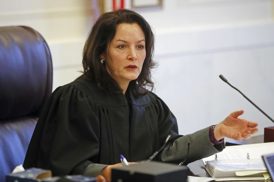 FILE – In this Jan. 23, 2017, file photo, Hamilton County, Ohio, Common Pleas Court Judge Leslie Ghiz meets with attorneys concerning the retrial of former University of Cincinnati police officer Ray Tensing in the July 19, 2015, traffic stop shooting death of motorist Samuel DuBose, during a hearing in Cincinnati. Ghiz scheduled a Monday, Feb. 27, 2017, meeting to get an update from prosecutors and defense attorneys before she presides over Tensing's retrial set to begin May 25, 2017, after the first trial ended with a hung jury. (AP Photo/John Minchillo, File)