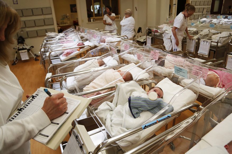 In this Thursday, Feb. 16, 2017 photo, newborn babies are attended to in the nursery of Aishes Chayil, a postpartum recovery center, in Kiryas Joel, N.Y. (AP Photo/Seth Wenig) ** FILE **
