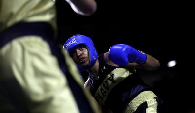 In this Feb. 24, 2017 photo, Midshipman Jordan Davis, of Pensacola, Fla., competes with Peter Ventola of Boston in a 175-lb boxing match during the U.S. Naval Academy&#39;s Brigade Boxing Championships in Annapolis, Md. (AP Photo/Patrick Semansky)