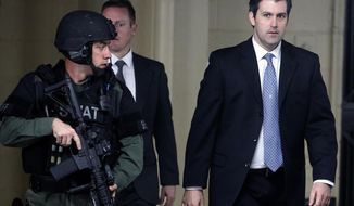 FILE - In this Monday, Dec. 5, 2016, file photo, Michael Slager, right, walks from the Charleston County Courthouse under the protection of the Charleston County Sheriff&#x27;s Department after a mistrial was declared for his trial in Charleston, S.C. Slager, a former South Carolina police officer charged with killing an unarmed black man running from a traffic stop, says he needs a public defender. (AP Photo/Mic Smith, File)