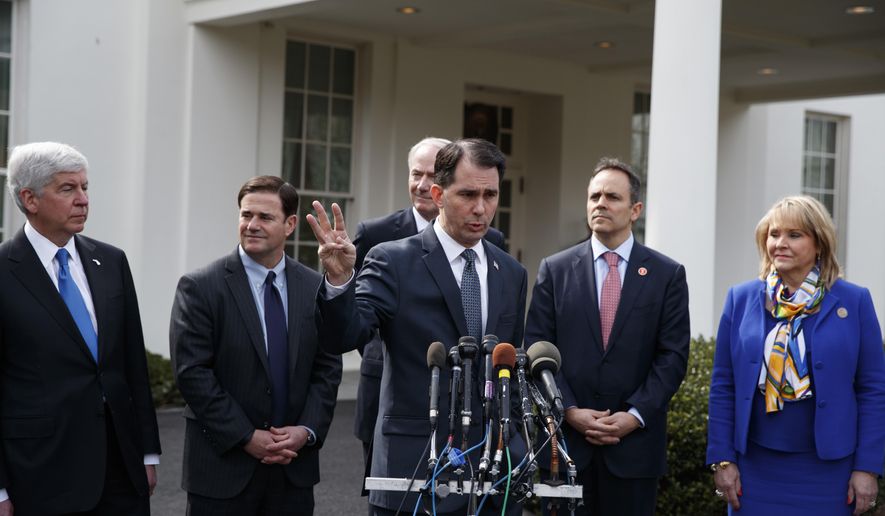 Wisconsin Gov. Scott Walker, center, gestures as he speaks to reporters outside the White House in Washington, Monday, Feb. 27, 2017, following a meeting with President Donald Trump inside. From left are, Michigan Gov. Rick Snyder, Arizona Gov. Doug Ducey, Arkansas Gov. Asa Hutchinson, Walker, Kentucky Gov. Matt Bevin and Oklahoma Gov. Mary Fallin. (AP Photo/Evan Vucci)