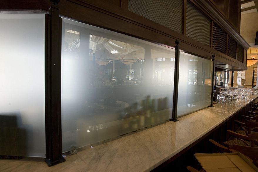 In this photo taken in 2011, a frosted glass curtain hides a portion of the bar at Brio Tuscan Grille at Fashion Place Mall in Murray City, Utah. In heavily Mormon Utah, a lawmaker introduced a proposal Monday, Feb. 27, 2017, that allows restaurants to get rid of barriers known as "Zion Curtains" that block people from seeing alcoholic drinks being made. (Paul Fraughton/The Salt Lake Tribune via AP)