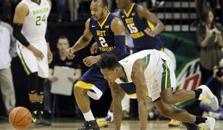 West Virginia&#39;s Jevon Carter (2) and Baylor&#39;s Wendell Mitchell, bottom, chase after a loose ball int he first half of an NCAA college basketball game, Monday, Feb. 27, 2017, in Waco, Texas. (AP Photo/Tony Gutierrez)