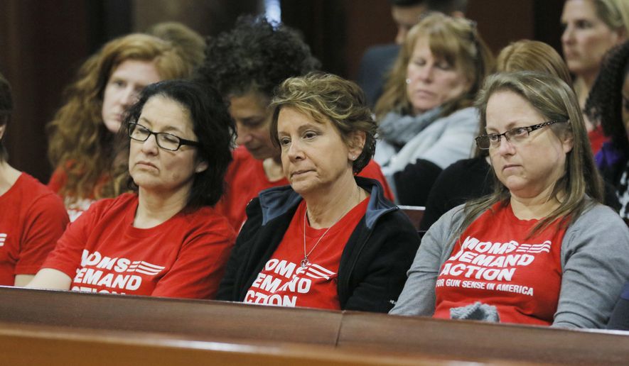 Woman from the group Moms Demand Action watch as the campus Carry bill advances Monday, Feb. 27, 2017, at the legislature in Atlanta. With little fanfare, the House Public Safety and Homeland Security Committee om Monday approved what has become known as the "Campus Carry" bill. Ballinger is the sponsor of HB 280, which allows anyone with a Georgia weapons permit to carry firearms onto most parts of public college and university campuses. (Bob Andres/Atlanta Journal-Constitution via AP)