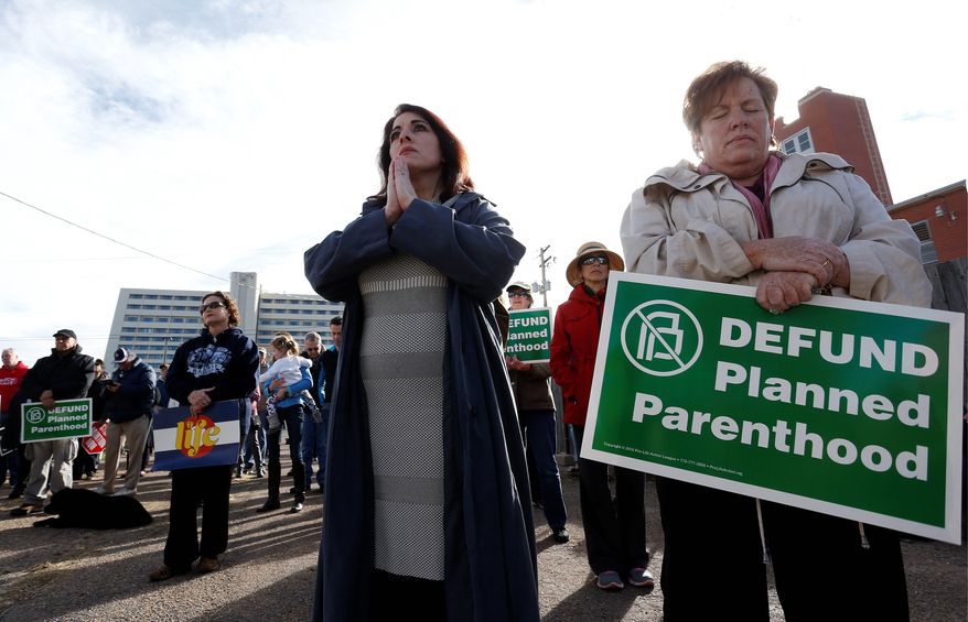 Participants in an anti-abortion rally hold signs and pray as they listen to a member of Christian clergy read from the Bible, in front of Planned Parenthood of the Rocky Mountains, in Denver, Saturday, Feb. 11, 2017. Anti-abortion activists emboldened by the new administration of President Donald Trump staged rallies around the country Saturday calling for the federal government to cut off payments to Planned Parenthood. (AP Photo/Brennan Linsley) (Associated Press)