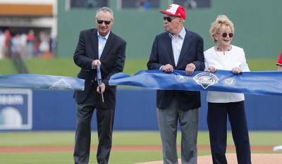 Major League Baseball commissioner Rob Manfred (left) cuts the ceremonial ribbon to open The Ballpark of the Palm Beaches as Washington Nationals owner Ted Lerner and his wife Annette look on before Tuesday&#x27;s spring training game. (Associated Press)