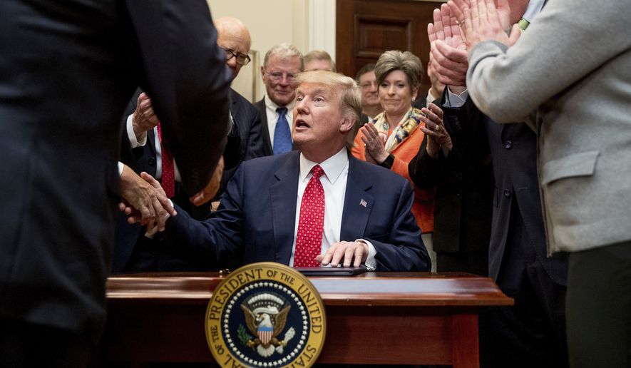 President Donald Trump shakes hands after signing the Waters of the United States (WOTUS) executive order, Tuesday, Feb. 28, 2017, in the Roosevelt Room in the White House in Washington, which directs the Environmental Protection Agency to withdraw the Waters of the United States (WOTUS) rule, which expands the number of waterways that are federally protected under the Clean Water Act. (AP Photo/Andrew Harnik) **FILE**