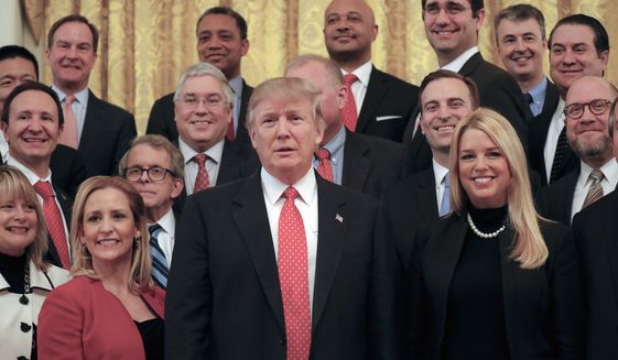 President Donald Trump poses for a photo with the National Association of Attorneys General, Tuesday, Feb. 28, 2017, in the East Room of the White House in Washington. (AP Photo/Pablo Martinez Monsivais)