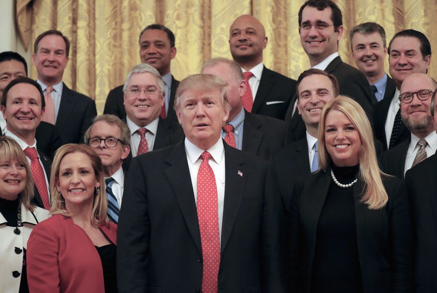 President Donald Trump poses for a photo with the National Association of Attorneys General, Tuesday, Feb. 28, 2017, in the East Room of the White House in Washington. (AP Photo/Pablo Martinez Monsivais)