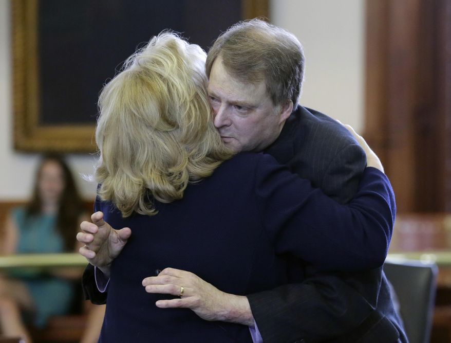 Texas Sen. Brian Birdwell, R-Granbury, right, is hugged by Sen. Jane Nelson, R-Flower Mound, left, after a vote on a call for a "convention of states" that would amend the U.S. Constitution and impose things like a federal balanced budget requirement and term limits in the senate chamber, Tuesday, Feb. 28, 2017, in Austin, Texas. (AP Photo/Eric Gay)