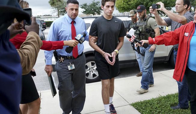 FILE - In this Monday, Oct. 3, 2016, file photo, Austin Harrouff is transported by detectives to the Martin County Jail from St. Mary&#x27;s Hospital in Florida. Harrouff, the Florida college student accused of randomly killing a couple and chewing on the dead man&#x27;s face, told TV personality Phil McGraw he had been running from a demon-like figure named Daniel before the attack. In a video released Tuesday, Feb. 28, 2017, by prosecutors, Harrouff told McGraw he only had vague memories of killing John Stevens and Michelle Mishcon last Aug. 15. (Richard Graulich/Palm Beach Post via AP)
