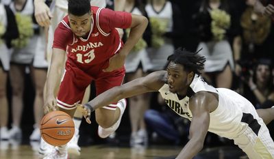 Indiana&#x27;s Juwan Morgan and Purdue&#x27;s Caleb Swanigan battle for a loose ball during the first half of an NCAA college basketball game Tuesday, Feb. 28, 2017, in West Lafayette, Ind. (AP Photo/Darron Cummings)