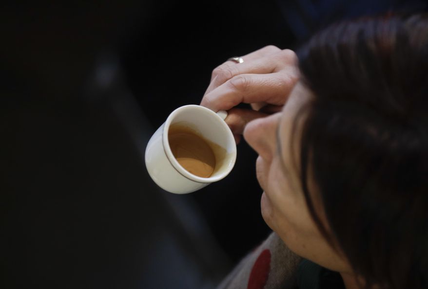 A customer drinks an espresso coffee at a traditional coffee bar in Milan, Italy, on Feb. 27, 2017. (Associated Press) **FILE**