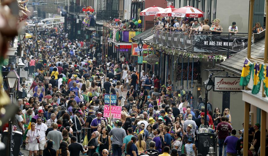 Revelers congregate on Bourbon Street as seen from the Royal Sonesta Hotel during Mardi Gras in New Orleans, Tuesday, Feb. 28, 2017. (AP Photo/Gerald Herbert)