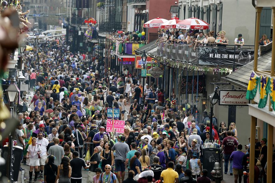 Revelers congregate on Bourbon Street as seen from the Royal Sonesta Hotel during Mardi Gras in New Orleans, Tuesday, Feb. 28, 2017. (AP Photo/Gerald Herbert)