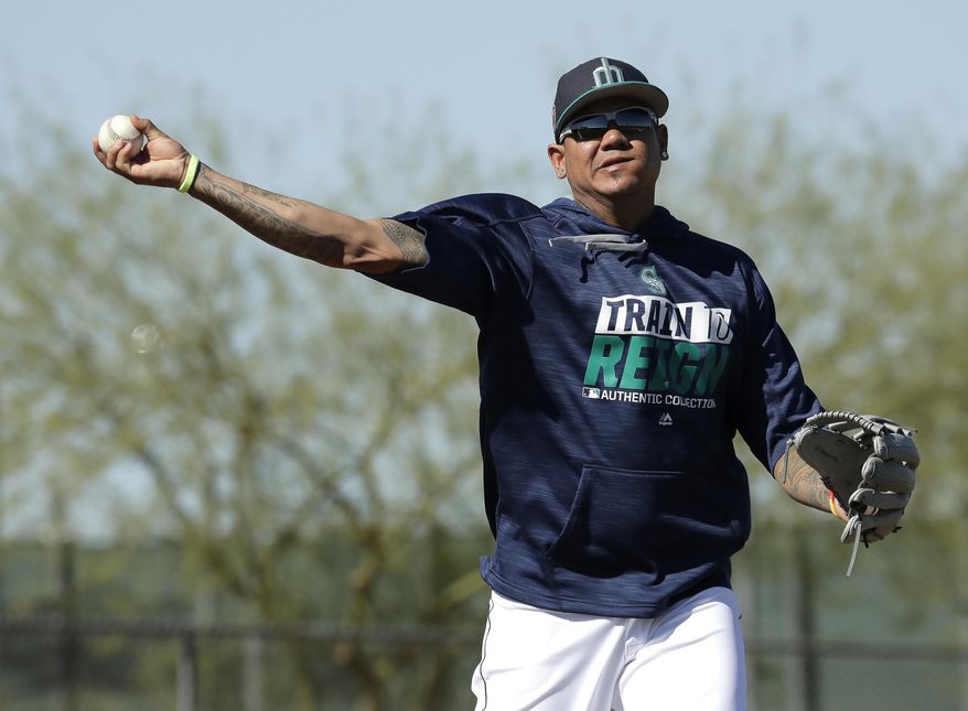 FILE - In this Feb. 15, 2017, file photo, Seattle Mariners pitcher Felix Hernandez participates in a drill during spring training baseball practice in Peoria, Ariz. Hernandez is beginning his climb back from one of his toughest seasons, when he went 11-8 with a 3.82 ERA and his lowest innings total since 2007. (AP Photo/Charlie Riedel, File)