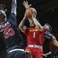 Maryland guard Jaylen Brantley (1) shoots as he splits Rutger guard Corey Sanders (3) and forward Issa Thiam (35) during the first half of an NCAA college basketball game Tuesday, Feb. 28, 2017, in Piscataway, N.J. (AP Photo/Mel Evans)