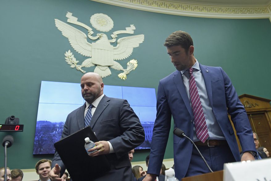 Olympic swimming champion Michael Phelps, right, and Olympic shot-put champion Adam Nelson, left, arrive on Capitol Hill in Washington, Tuesday, Feb. 28, 2017. to testify before the House Commerce Energy and Commerce subcommittee hearing on the international anti-doping system. (AP Photo/Susan Walsh)